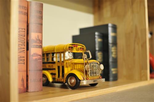 School bus toy on shelf 